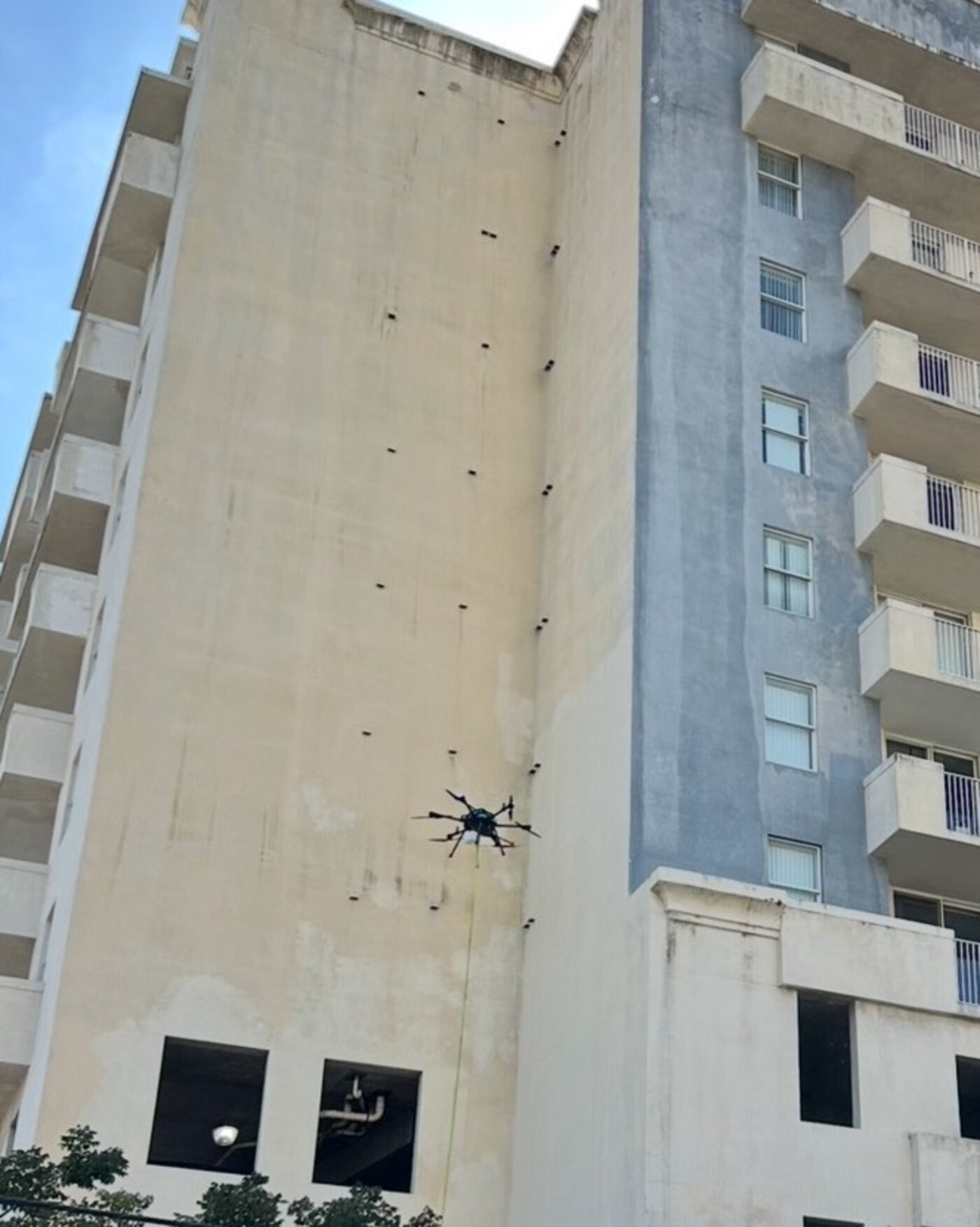 Drone cleaning high on a building